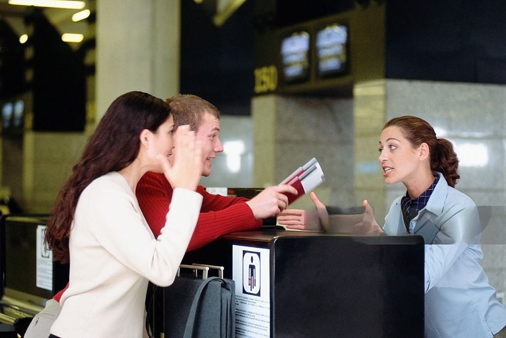 people angry at ticket counter at receptionist